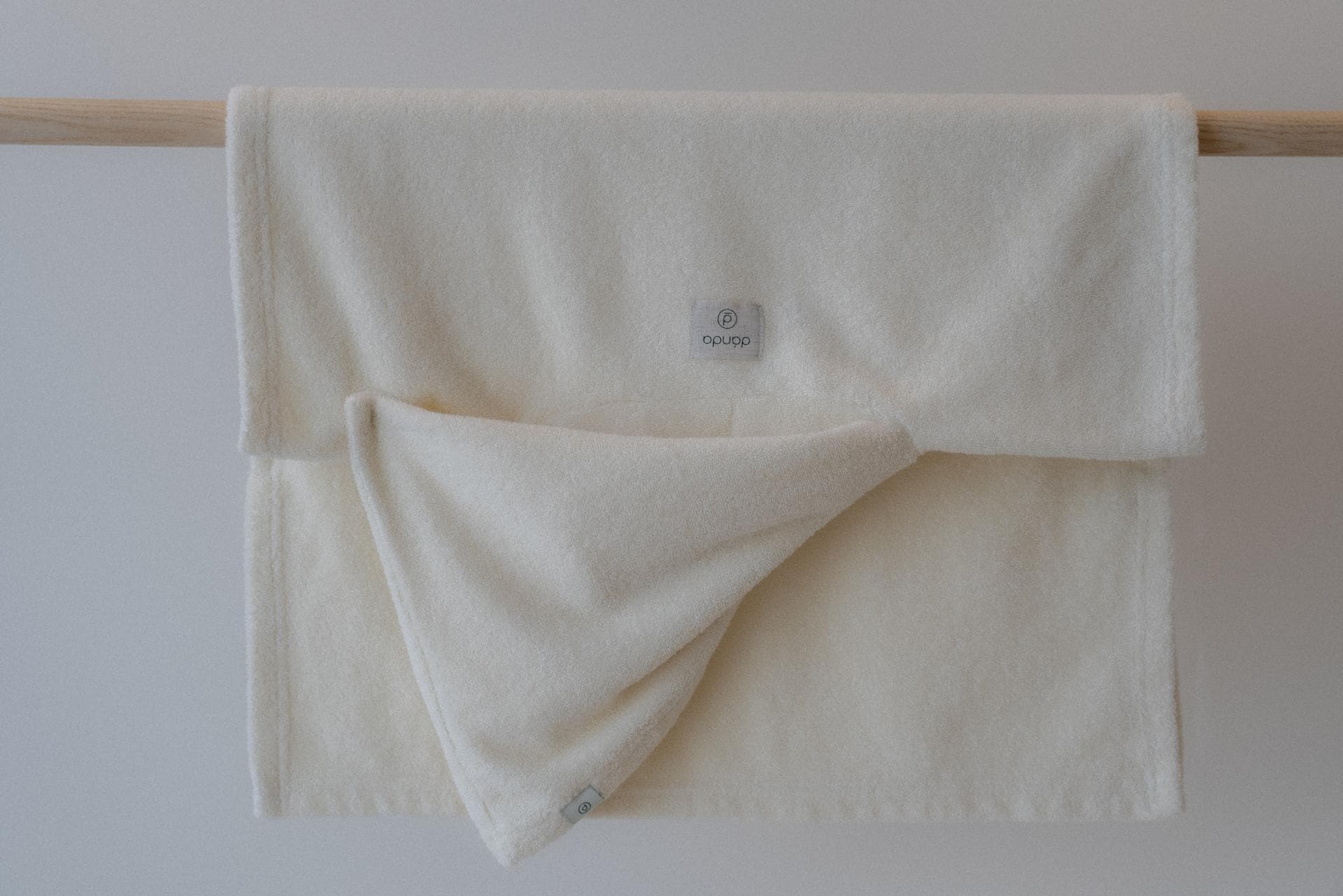 Close up of soft cream-colored textile with gentle stripe patterns.