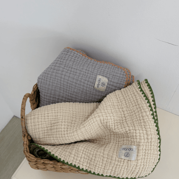 Five colorful danda-branded bibs fanned out elegantly.